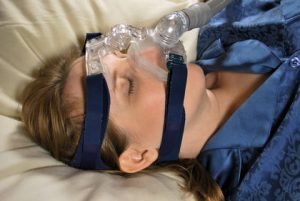 Woman Wearing CPAP Breathing Machine Mask
